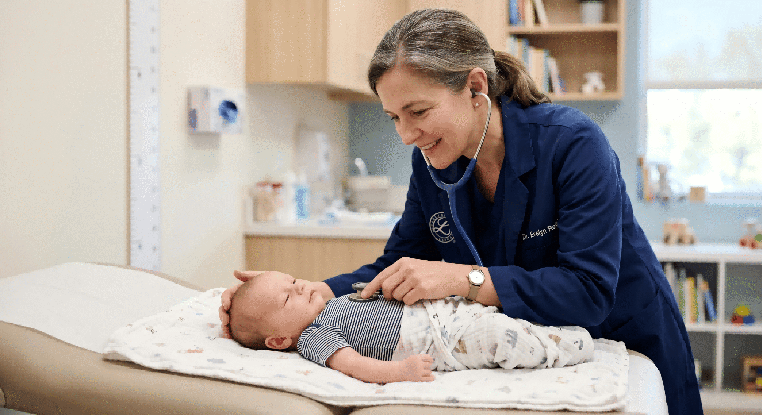 newborn baby having a health checkup with a stethoscope